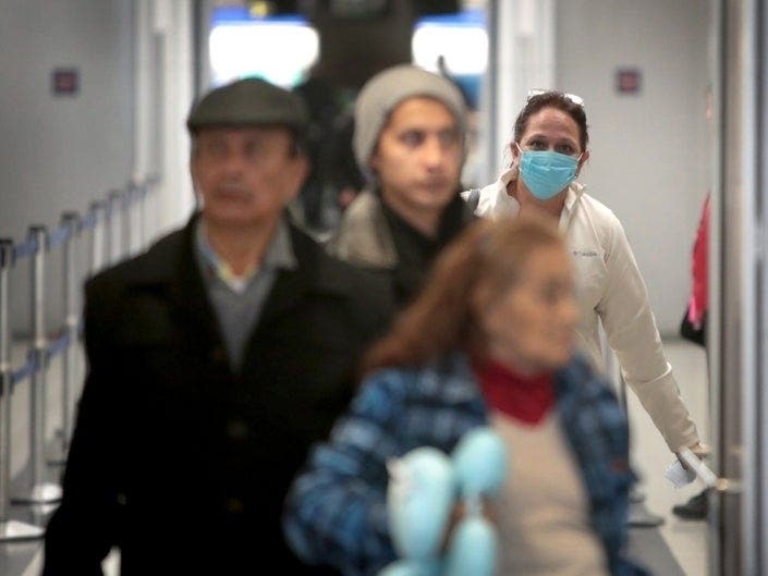 Travelers arrive in the international terminal at O'Hare Airport. Sunday was the last day for travelers from 26 European nations to fly into the United States after President Donald Trump instituted a 30-day travel ban.