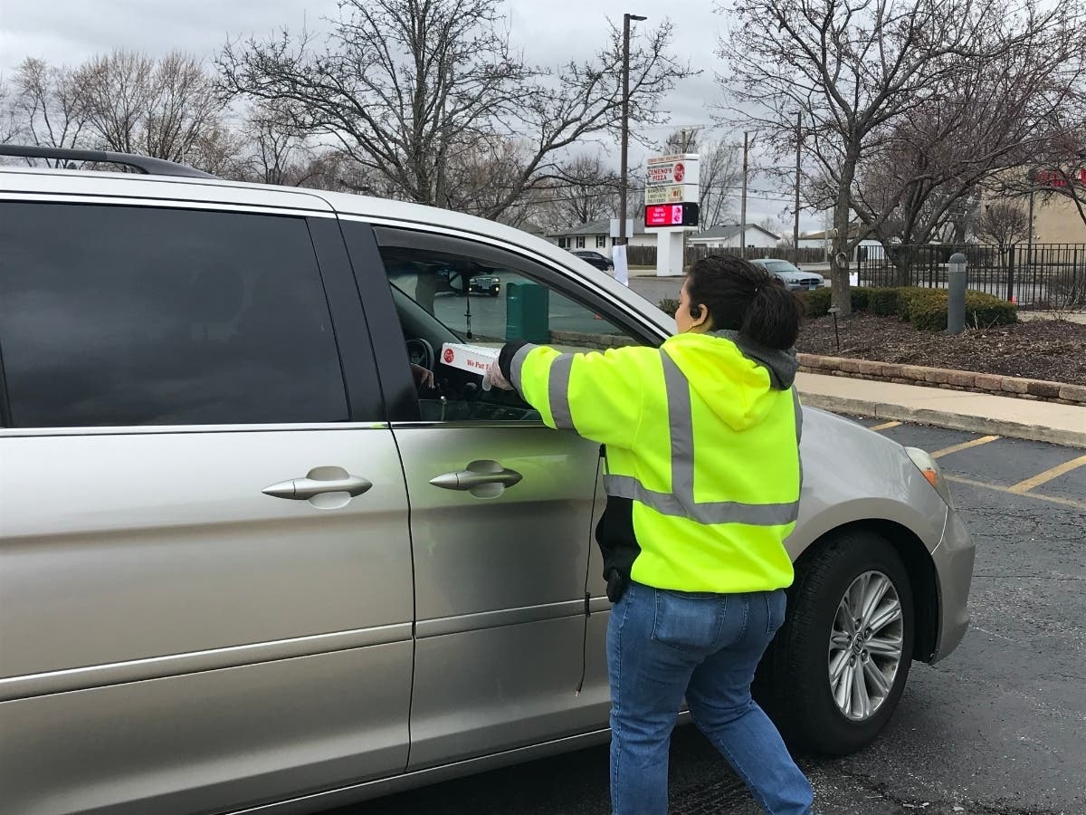 Employees at Cemeno's pizza on Essington Road in Joliet say they are keeping busy with carryout orders as families adjust their lives amid the coronavirus outbreak.