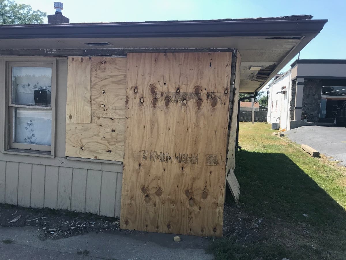 A view of the house damaged by the actions of a Joliet woman who was riding as a passenger in a car, according to Crest Hill police.