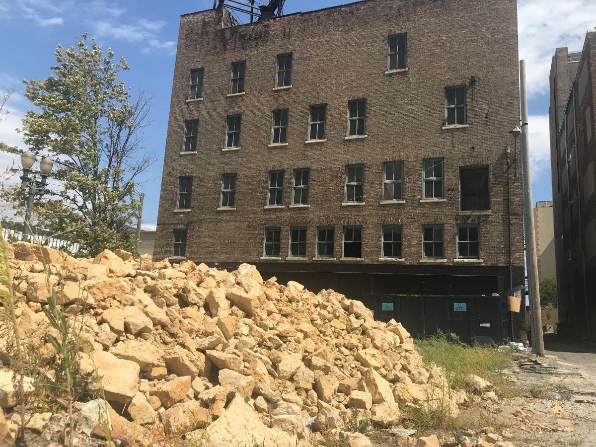 A giant pile of unsecured rocks remains behind the old Barrett's Hardware property in downtown Joliet. 