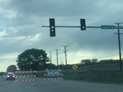 Joliet police officers detour traffic away from Route 6 at Houbolt Road around 8 a.m. Friday as they investigate an overnight traffic fatality about a mile down the road. 