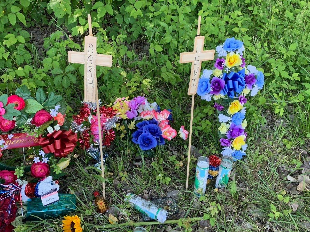 Crosses and flowers are erected in Joliet  along Route 6 to memorialize Sara Altiery, 27, and her son, Levi Eichelberger. Both died in a traffic crash in late May. 