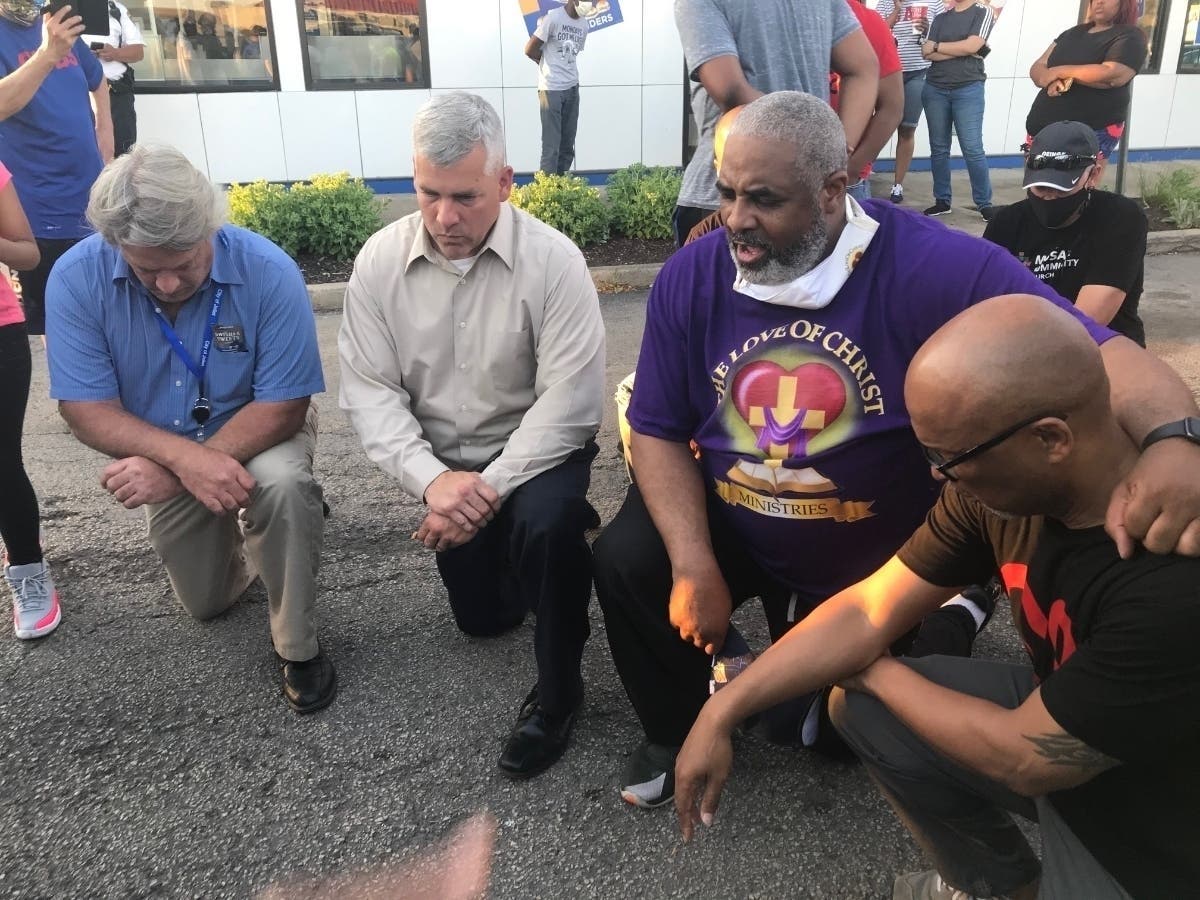 On June 2, 2020, Joliet City Councilman Larry Hug and Mayor Bob O'Dekirk kneel for a prayer at a Black Lives Matter rally in front of Joliet's White Castle. 