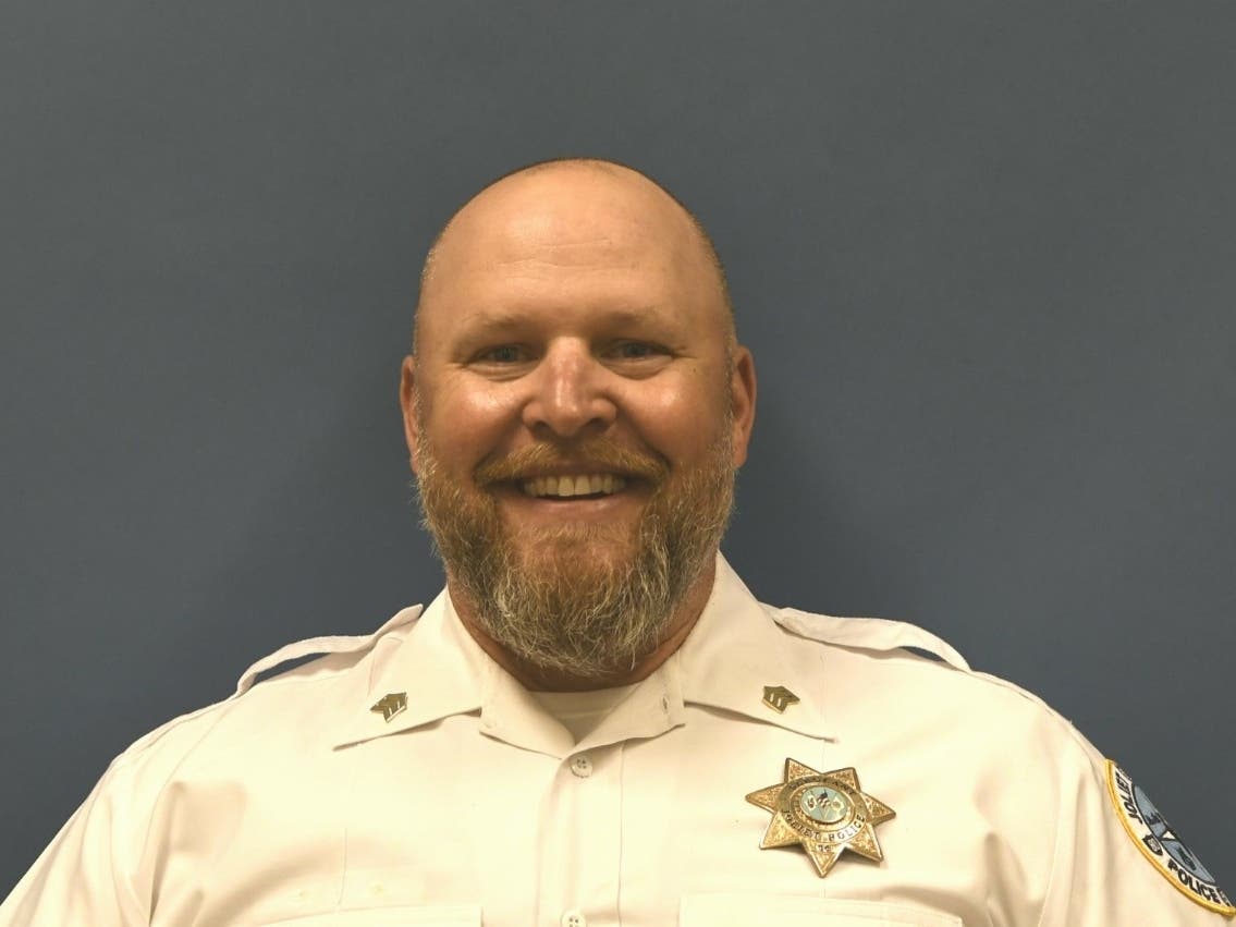 According to Nicole Lurry's federal lawsuit, as her husband, Eric Lurry, 37, was losing consciousness in the back of the squad car, Joliet Police Sgt. Doug May (pictured) smacked him in the head and declared, "Wake up, bitch!" 