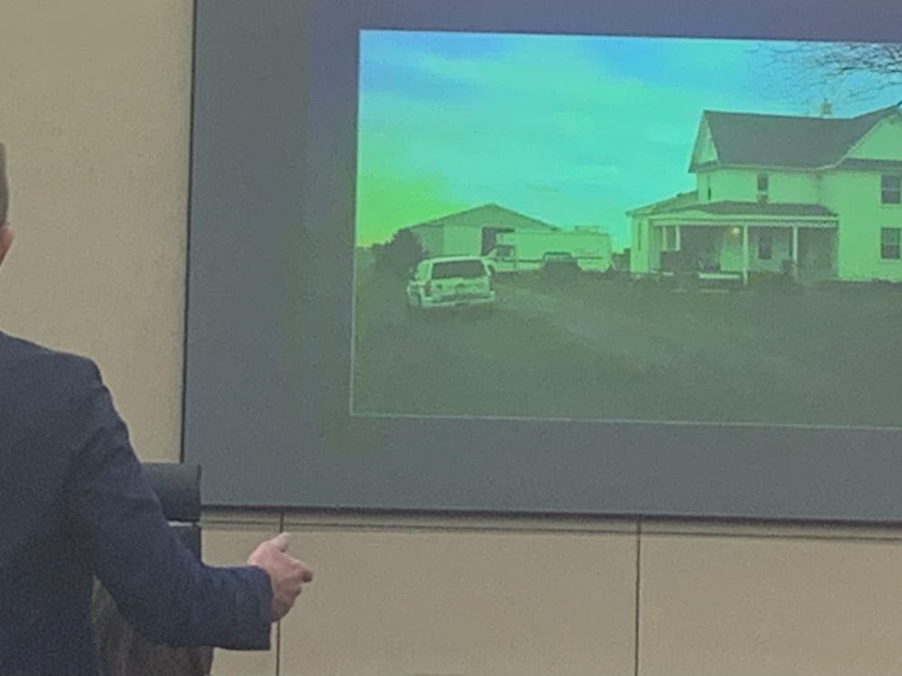 Assistant Will County State's Attorney Dan Egan displays a photo showing the farmhouse and pole barn in St. Anne where the body of Joliet bartender Katie Kearns was found in her Jeep. 