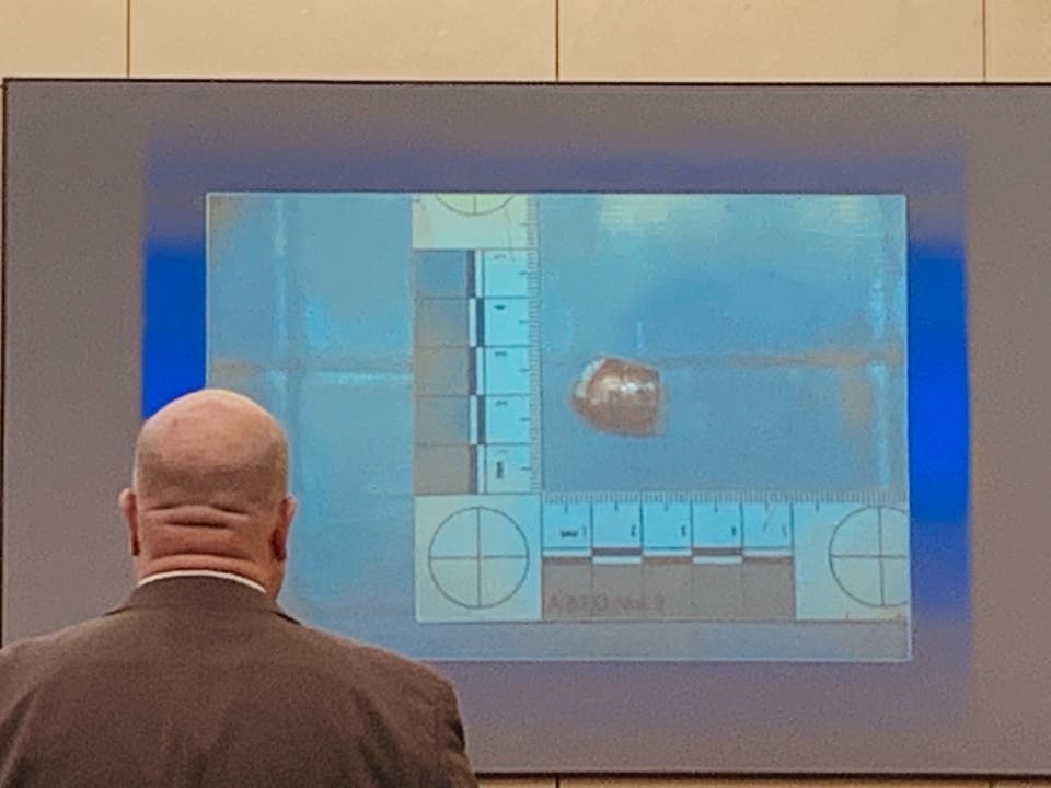 Assistant State's Attorney Steven Platek shows jurors the fatal bullet that ended up inside the ceiling of the Joliet Outlaws Clubhouse during the early morning hours of Nov. 13, 2017.