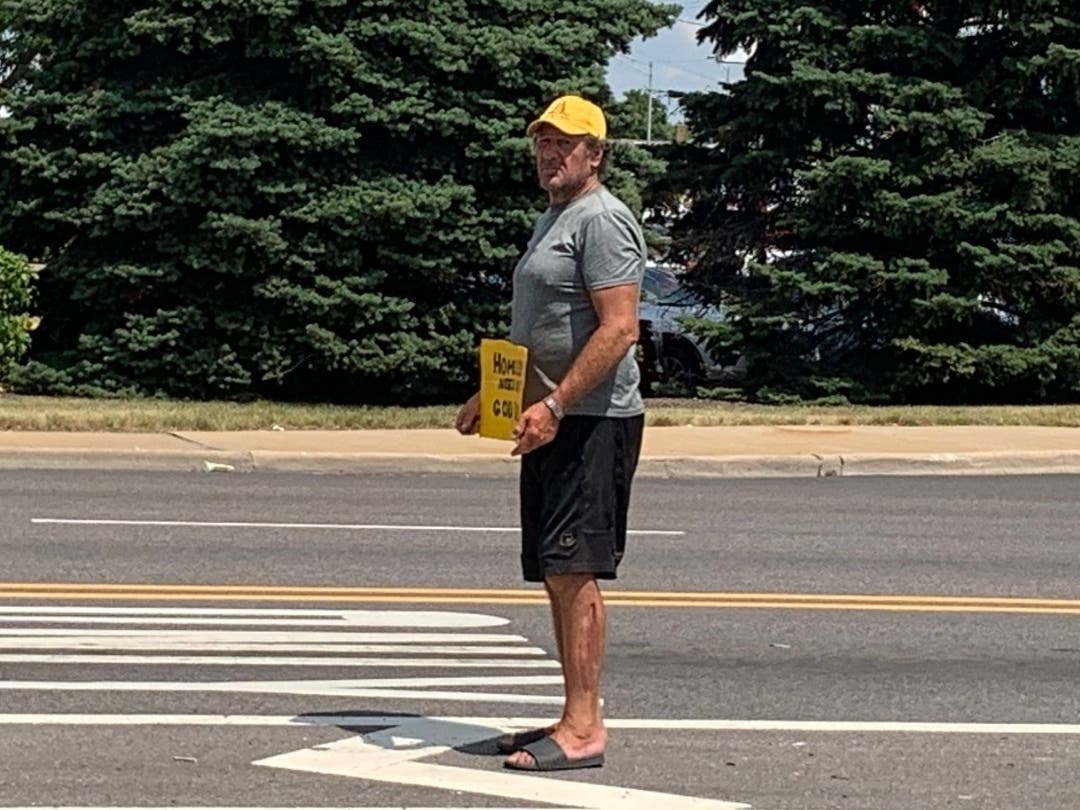 On Tuesday, this man holding a homeless sign was panhandling in the middle of Joliet's Larkin Avenue while cars and semitrailers zipped by near the White Castle. 