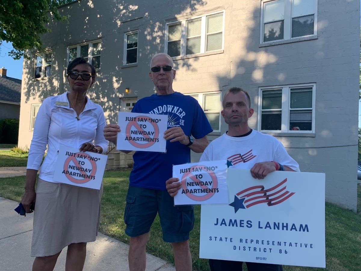 From left: Diane Harris, John Sheridan and Jim Lanham stand outside 1000 Cora Street in Joliet on June 23. NewDay Apartments has six out-of-town child sexual predators living here, according to Mayor Bob O'Dekirk. 