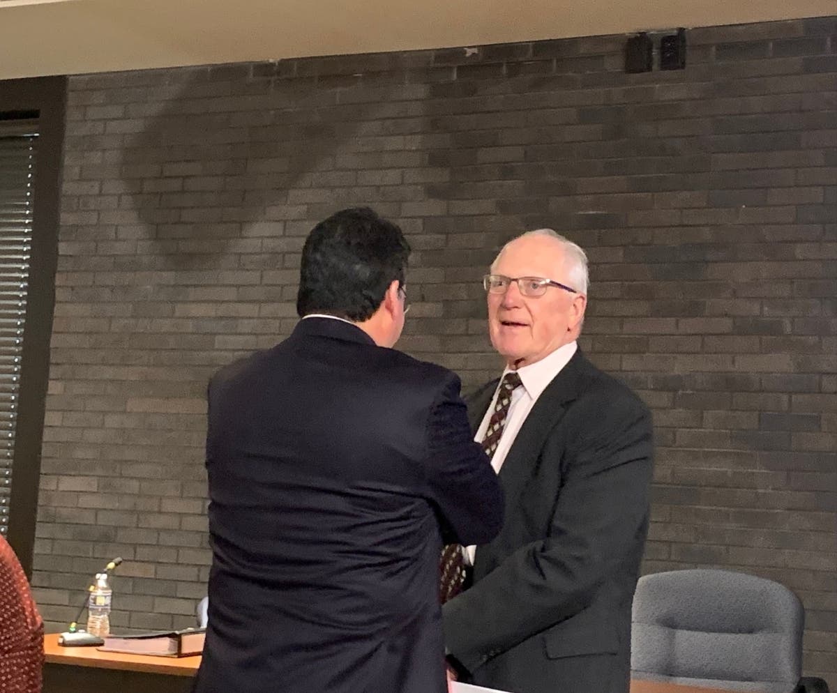 Joliet City Councilman Pat Mudron meets with attorney Ricardo Meza of Chicago's Meza Law before Monday's special meeting. 