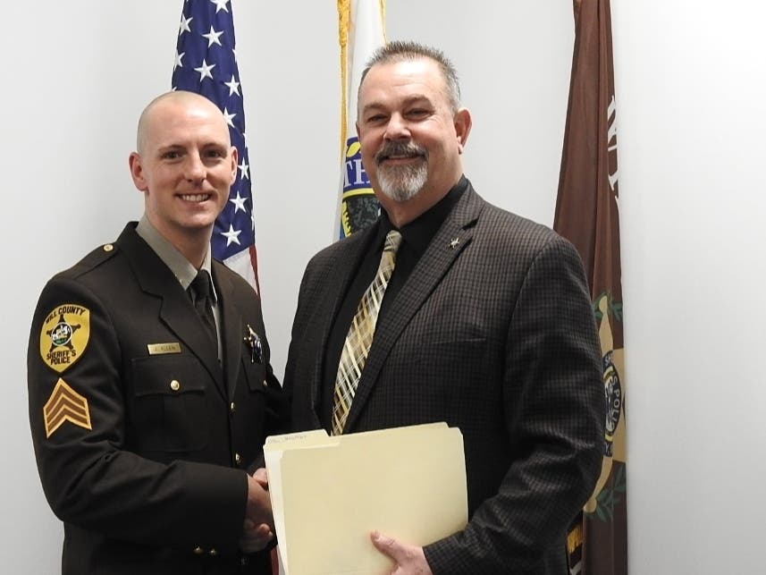In February 2022, Will County Sheriff Mike Kelley congratulates Sgt. John Allen on his promotion to lieutenant. Kelley and Allen are now co-defendants in a wrongful death lawsuit. 