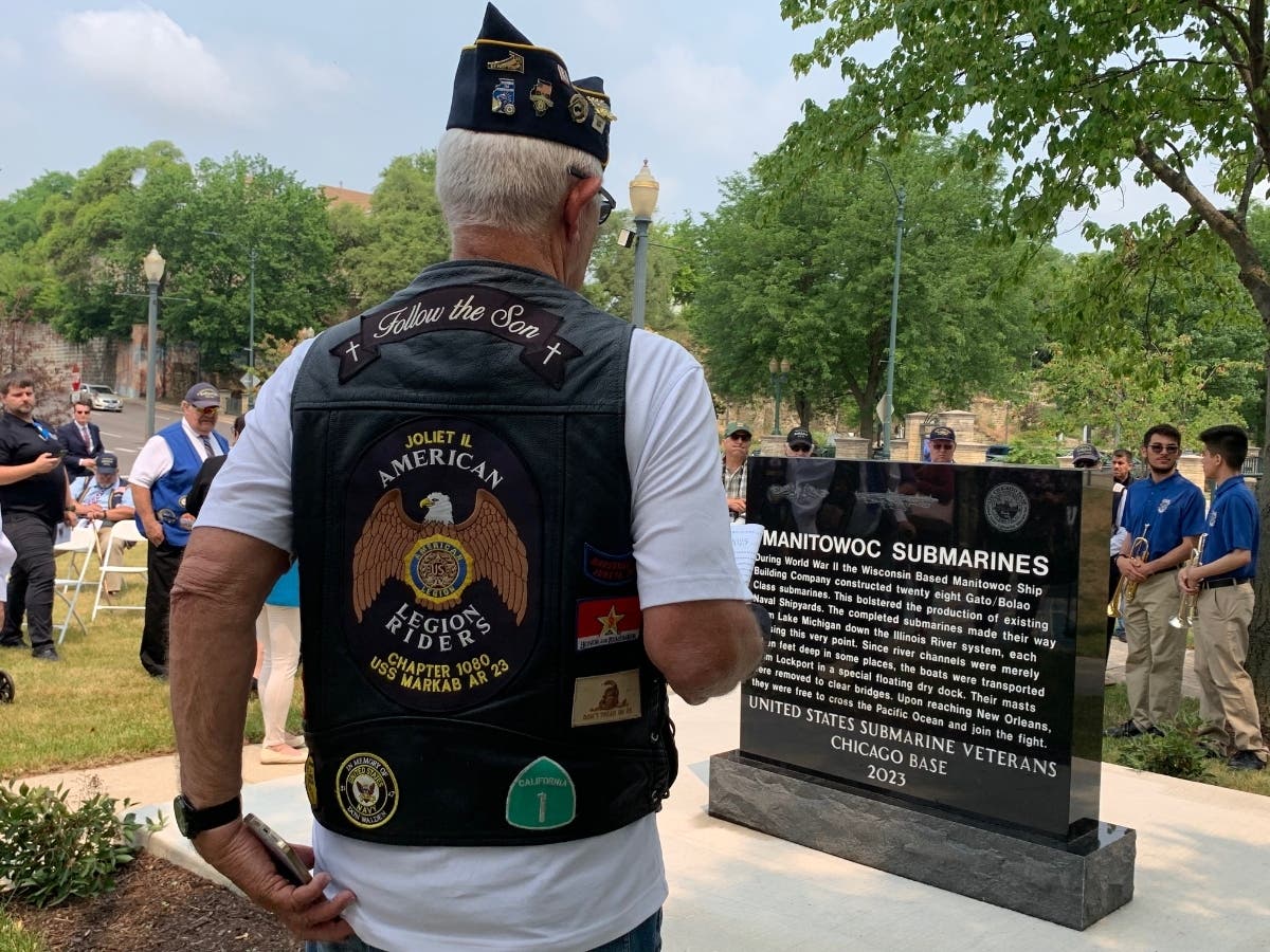 On the front side of the new Joliet monument are replicas of Navy submarine dolphins and the USS Chicago Base logo, followed by a description of the Manitowoc Submarines story.