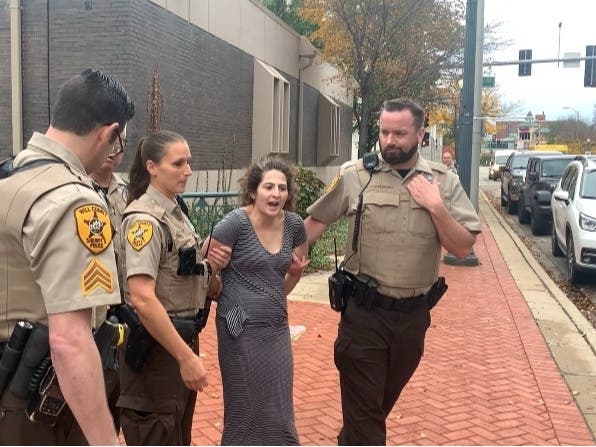 Alissia Huet of Bolingbrook gets arrested outside Joliet's City Hall after authorities say she caused a huge disturbance at Will County's Courthouse across the street on Thursday.