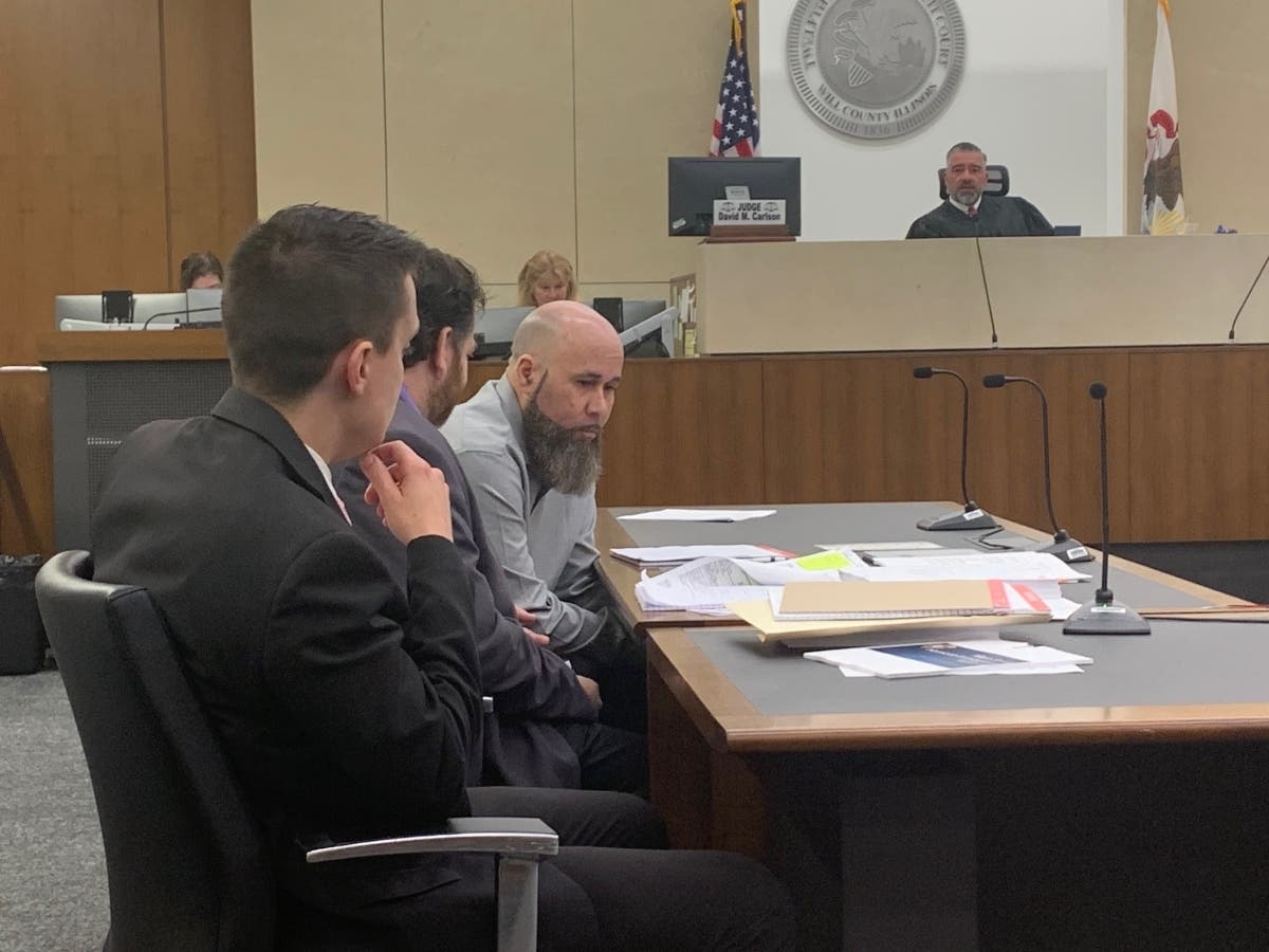 Jermaine Mandley, with a gray shirt and long beard, sits next to his two Will County Public Defenders, Will County Public Defenders Zack Strupeck and Phil Villasenor, following jury instructions from Judge Dave Carlson back in August. 