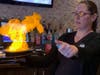 Metro Grill & Bar manager Bobbie Dolgner lights up the saganaki. The Metro Grill menu describes the appetizer as "flavorful flamed Greek cheese." 