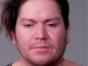 Police say a man was arrested after he was seen beating a rooster outside a Joliet grocery store.