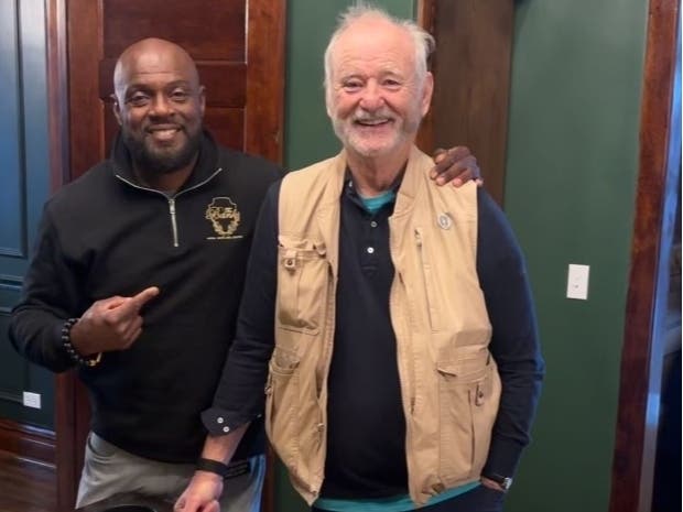 Lockport native Kenny Banks, a former U.S. Olympic track star, stands with comedian and Hollywood movie star Bill Murray last week inside The Banks Bridal Suites and Lodging, downtown Joliet's newest attraction, at 317 North Chicago Street. 