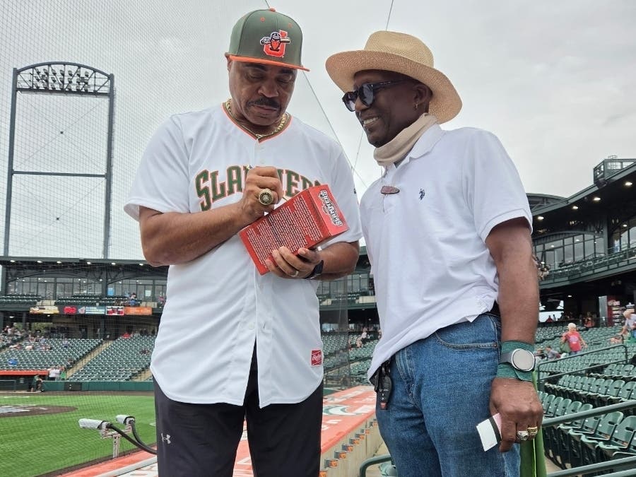 Jesse Barfield signs one of his replica Jesse Barfield statues at Joliet Slammers Stadium on Friday.