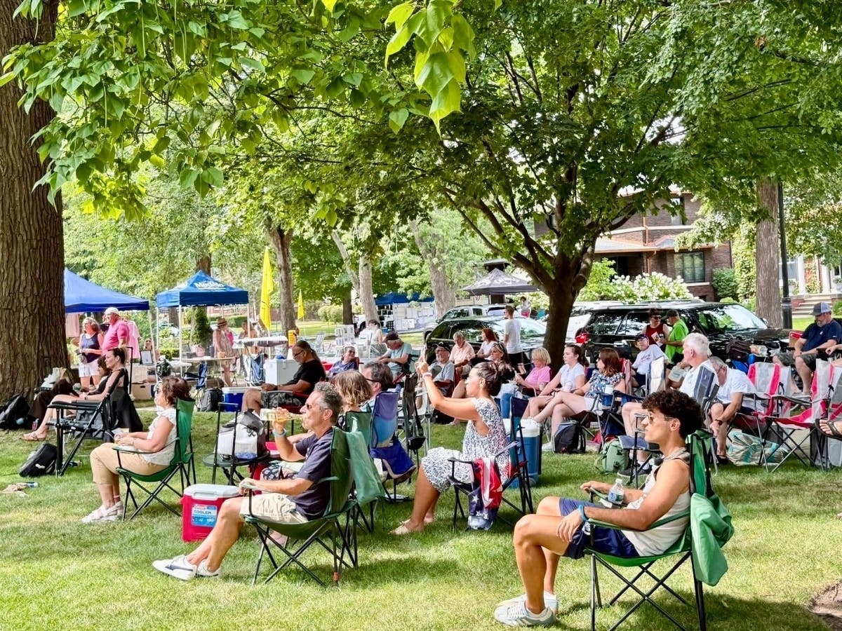 Patrons enjoy music at a Western Ave. porch.