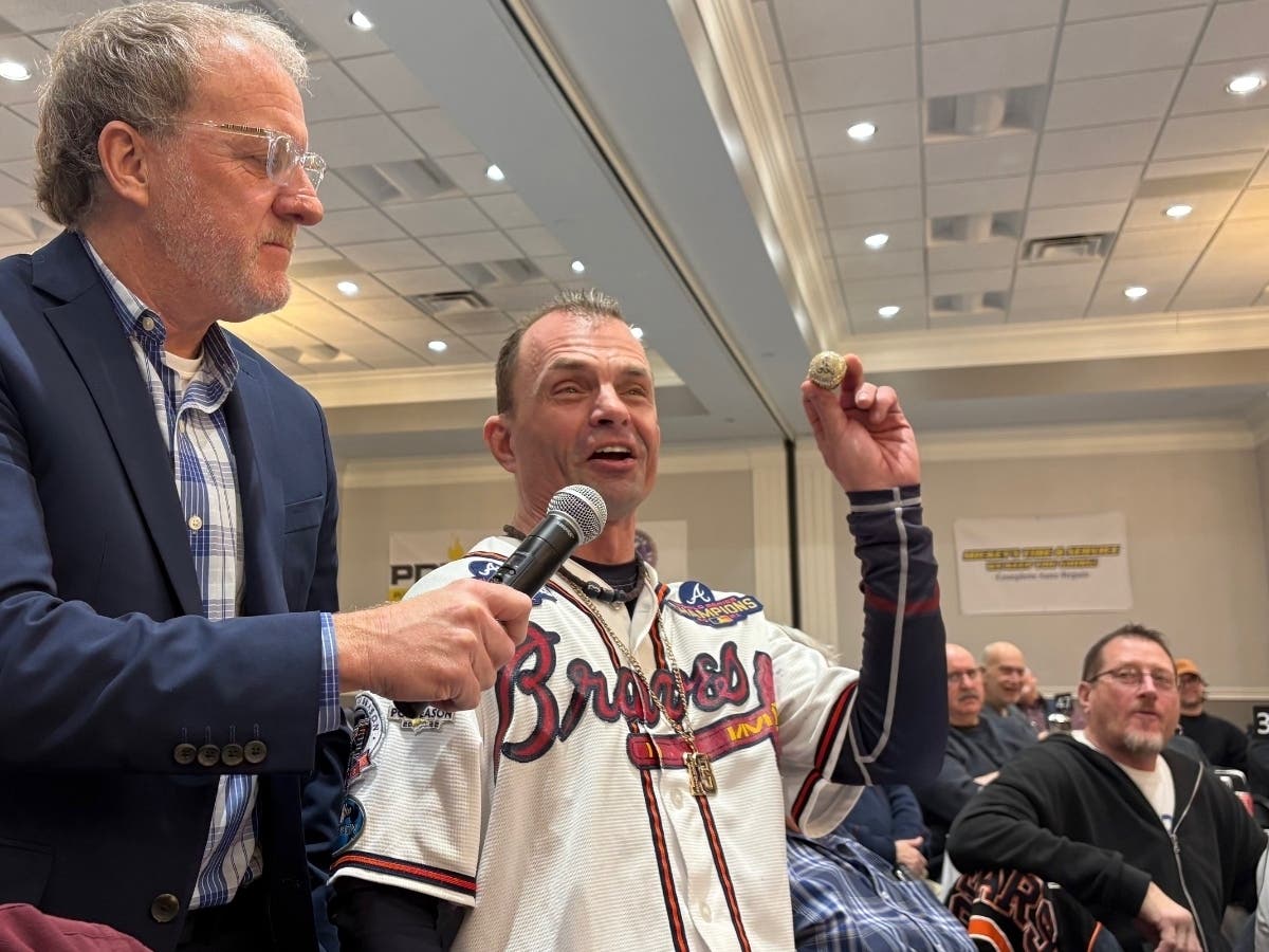 WJOL's Scott Slocum served as master of ceremonies at January's 75th annual Will County Old Timers Baseball Reunion as Jim Lanham asks a baseball salary cap question to Chicago Cubs announcer Ron Coomer, the guest speaker.