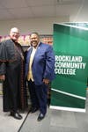 Timothy Cardinal Dolan poses in the food pantry with Dr. Michael Baston, President of Rockland Community College