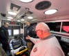 Commissioner Carey Welt (right) and firefighter Michael Cody (left) show Senator Thomas the latest state-of-the-art emergency medical equipment on board the fire department's newest ambulance. 