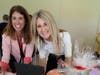 Christine Angles and Karen Amster Bidding on Silent Auction Items
