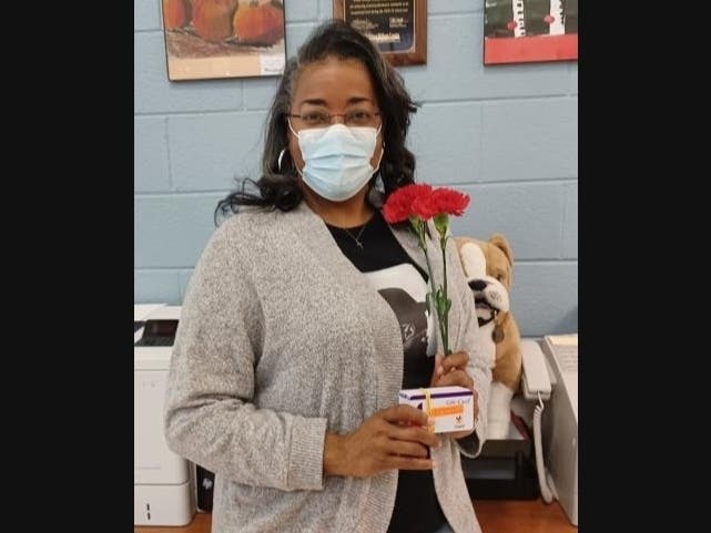 School Counselor with Grocery Gift Cards for Distribution 