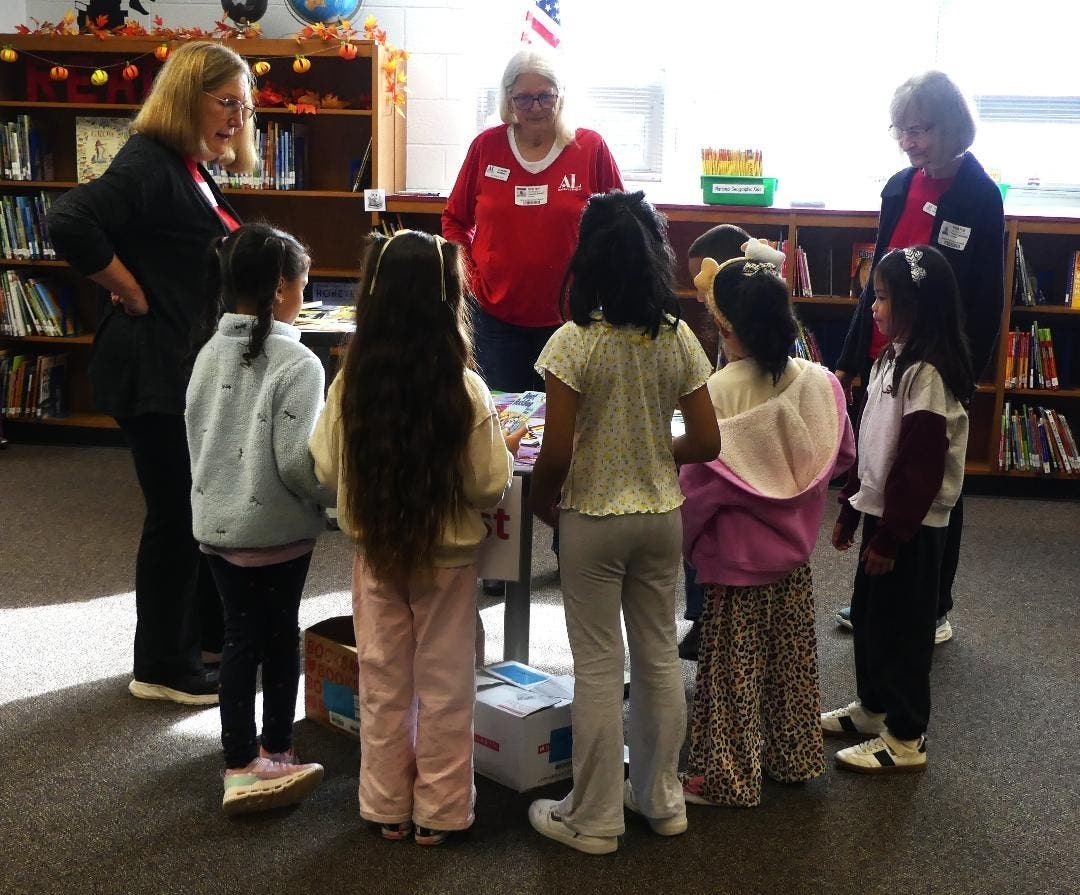 Assistance League Volunteers Helping Students Select Books at Build A Childs Library Event