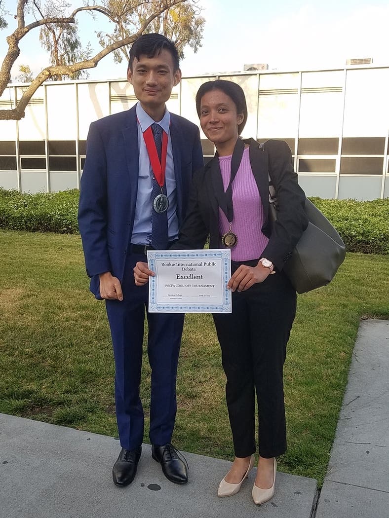 Chern Xun Gan (left) and Arundhati Ghosh with their medallions and certificate after the PSCFA Cool-Off awards ceremony.