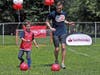 Askel and Odin Wathne of Newton warm up with goalkeeper Matt Turner of the New England Revolution before the Santander Public Clinic Series in Boston.