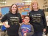 Teachers Kathleen Gessner (left) and Maureen McMorrow congratulate Lee Avenue fifth grader Danny, whose essay on his favorite 1,000th day of school memory was selected as best in the class. 