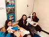 Art of Positive Living students at Hicksville High School display Smile Dolls they created for Operation Smile, an organization that helps children born with cleft lip or cleft palate conditions. 