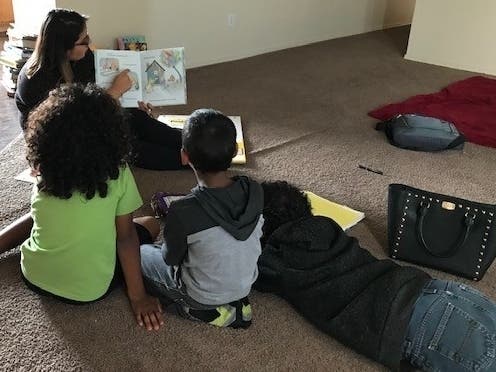 A representative from Olive Crest reads to children in the program. Olive Crest was awarded a $25,000 Coachella Valley Spotlight grant from the H.N. and Frances C. Berger Foundation.