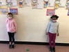 Third graders Natalie S. (left) and Keira E. displayed their Multiplication Menorahs.