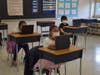 Students from LaFrancis Hardiman Elementary School and Wyandanch Memorial High School work on their Chromebooks provided by the district.