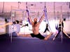 Chelsea Carter, Ricky James and Leslie Gerber practicing pole fitness and trapeze yoga.