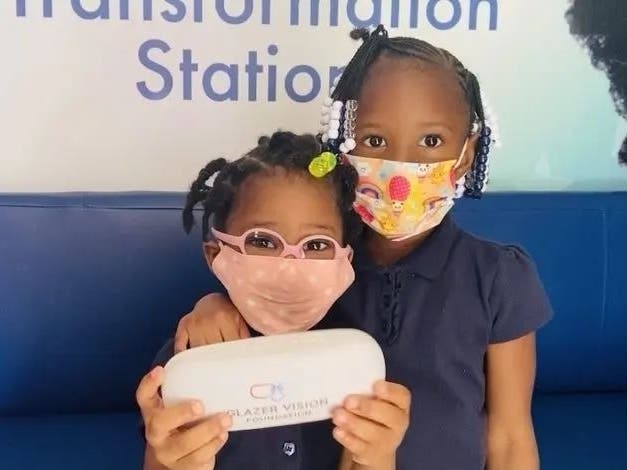 A Shore Elementary School in Tampa student shows off her new pink glasses thanks to the Lions Eye Institute and the Glazer Vision Foundation. 