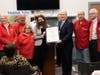 Sen. Kelly presents a citation recognizing the advocacy of Anna Doroghazi of AARP alongside volunteers including Pat Bright, Rich Bright, Mike Klein, Byron Peterson, and Fran Sinish.