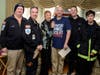Group photo in Bernadette Hoyer’s living room. Left to right, Squad 2nd Lt. Ed Winsor, Capt. Ian Lewis, Bernadette Hoyer, Eric Hoyer, Squad 1st Lt. Brian Downing and member Wesley Lewis.