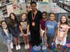 From left to right: Evelyn Ouyang, Jasmine Gioia, Avery Carter, MacDella Cooper, Katelynn Thomas, Varnika Pujari, and Kylie Fell stand proudly in front of their Capstone Projects (Girls in Steam and Women in Leadership).