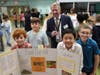 Woodland School Grade 5 students Jackson Plager, Danny Abreu, Josiah Nam, and Dylan Ditta explain their presentation to Executive County Superintendent Mr. Roger Jinks.