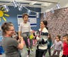 Mrs. Gabel and Mrs. Rosen teach the students how to dance The Hora while holding Maximiliano Salermo.