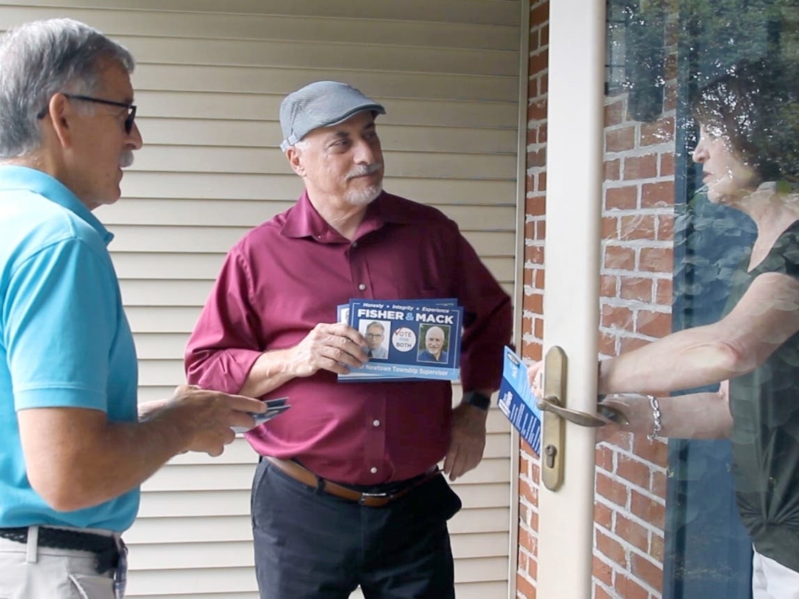 Dennis Fisher and John Mack meet a potential voter during the campaign.