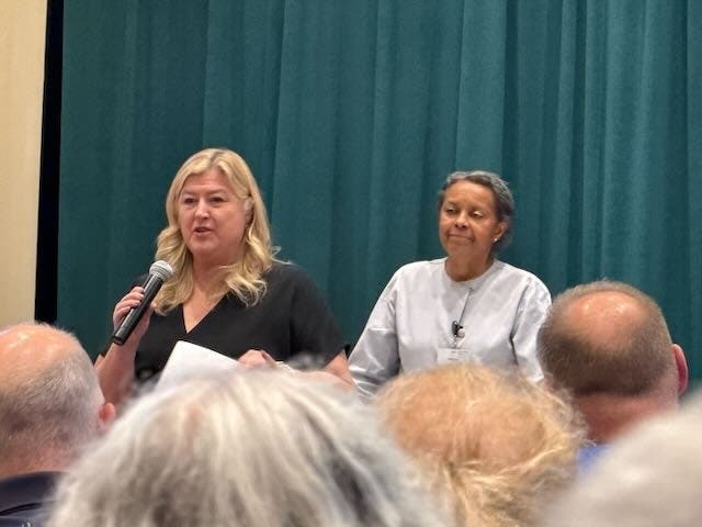 A representative of SilverWave (left) and Sherrin Johnson, Chair of the Chandler Hall Board, answer questions at the meeting.