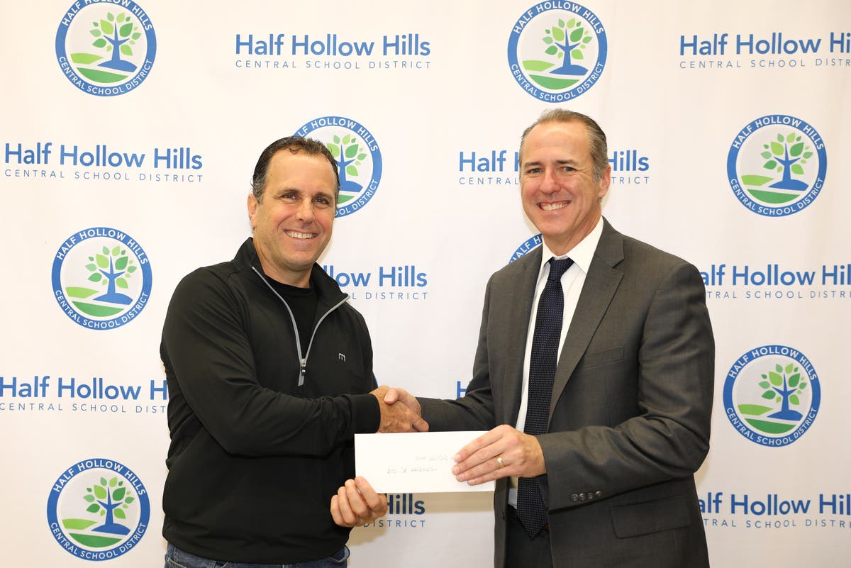 Superintendent Patrick Harrigan accepting donation from Matt Lulley, board member of the TCCP Memorial Foundation