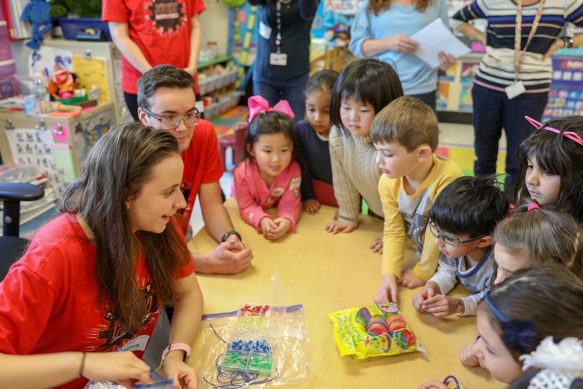 Members of FIRST Robotics Team teaching pre-K students about robotics.