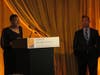 Althea Chin receives her award, as her colleague, orthopedic surgeon Jeffrey Leary, MD, listens.