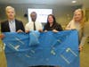 L-R, Summit Helping Its People's Christopher Cotter and Ramond Mangaroo hold a surgical wrap sleeping bag and pillow with Overlook's Melissa Bonassisa and Tami Ochs