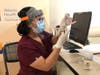 A member of Overlook's team prepares a dose of the COVID vaccine.