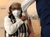 An Overlook team member receives one of the first shots of COVID vaccine